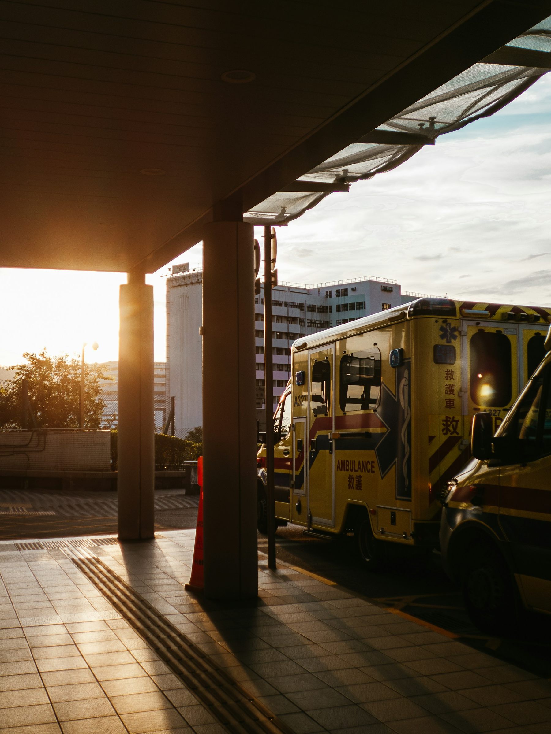 Ambulances outside a hospital at sunset