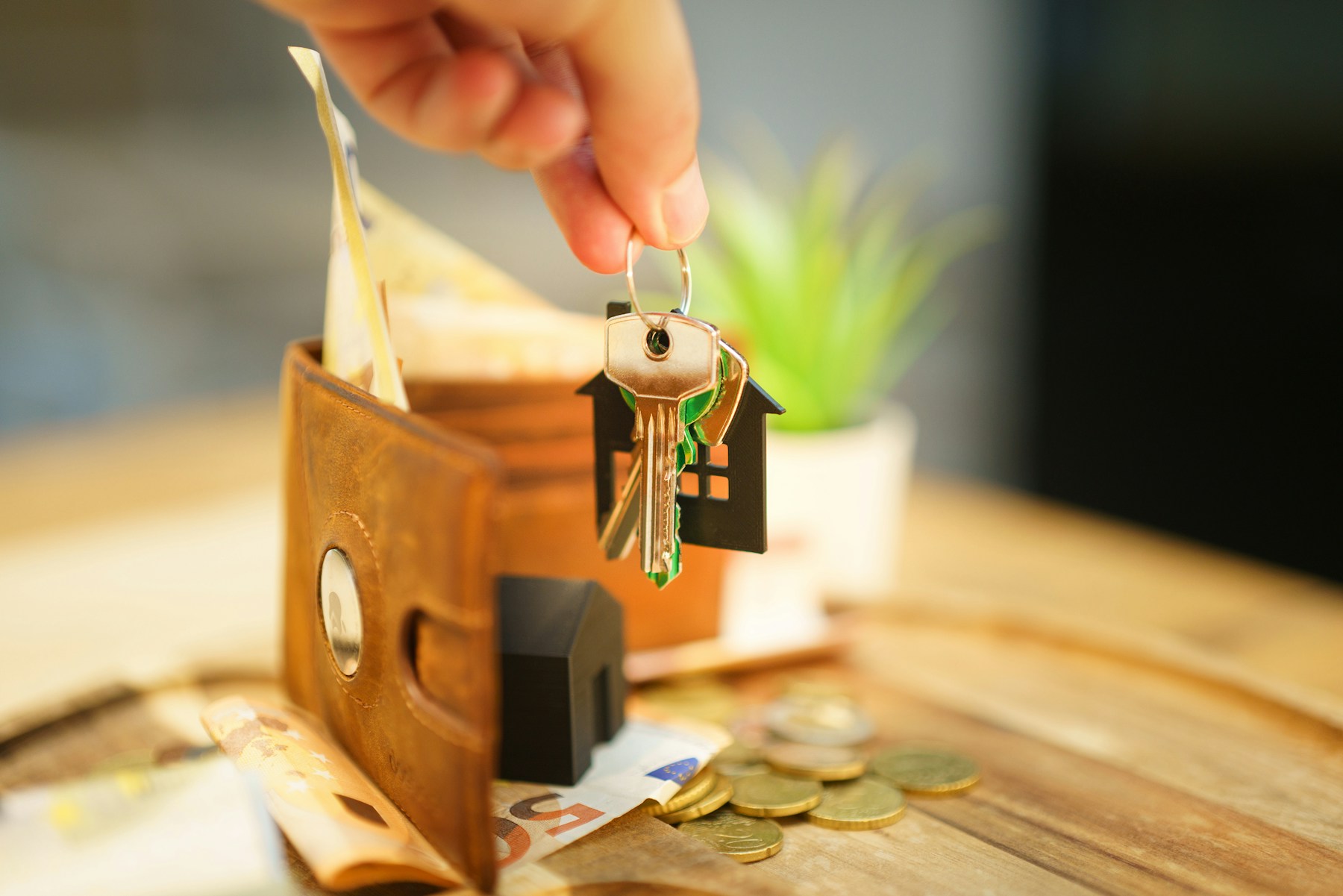 House keys held above a wallet
